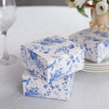 Decorative floral gift boxes stacked on a table.