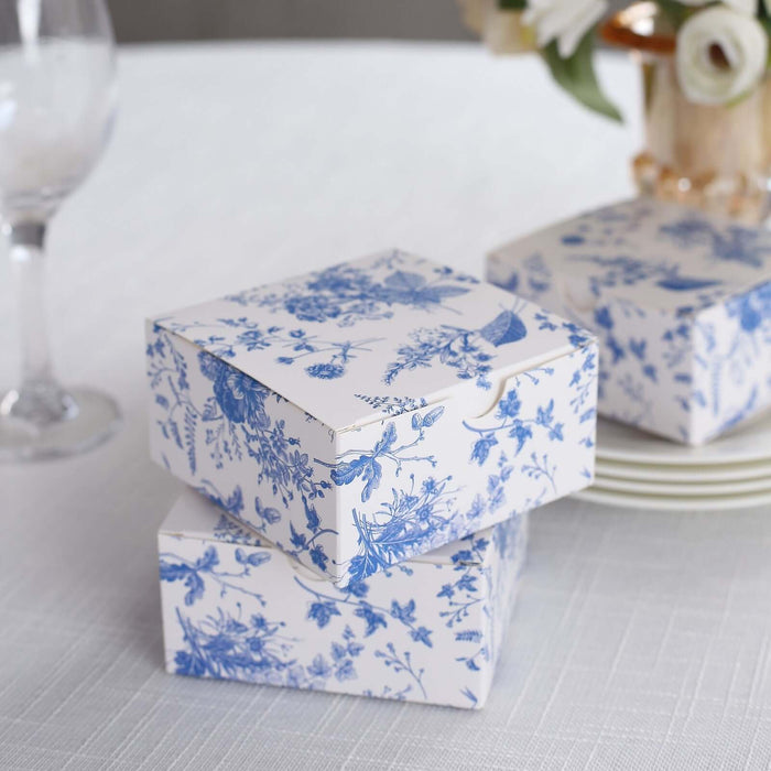 Decorative floral gift boxes stacked on a table.