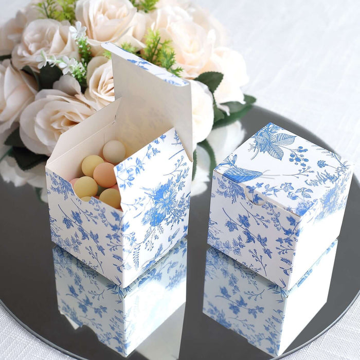 Decorative blue floral gift boxes with pastel candies inside.