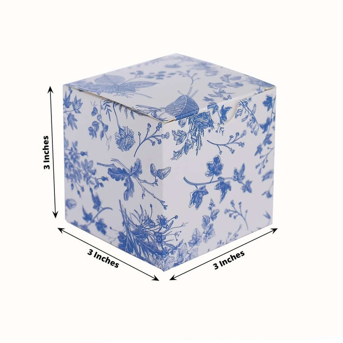 Blue floral patterned cube, 3 inches on each side.