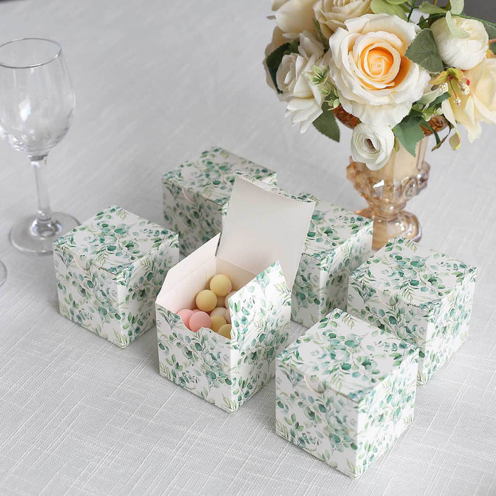Floral gift boxes with pastel candies, arranged elegantly on a table.