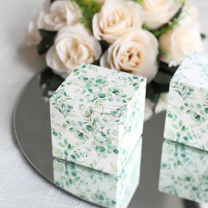 Decorative gift box with floral design on a reflective surface.
