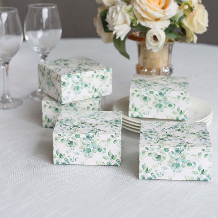 Decorative gift boxes with floral design arranged on a table.