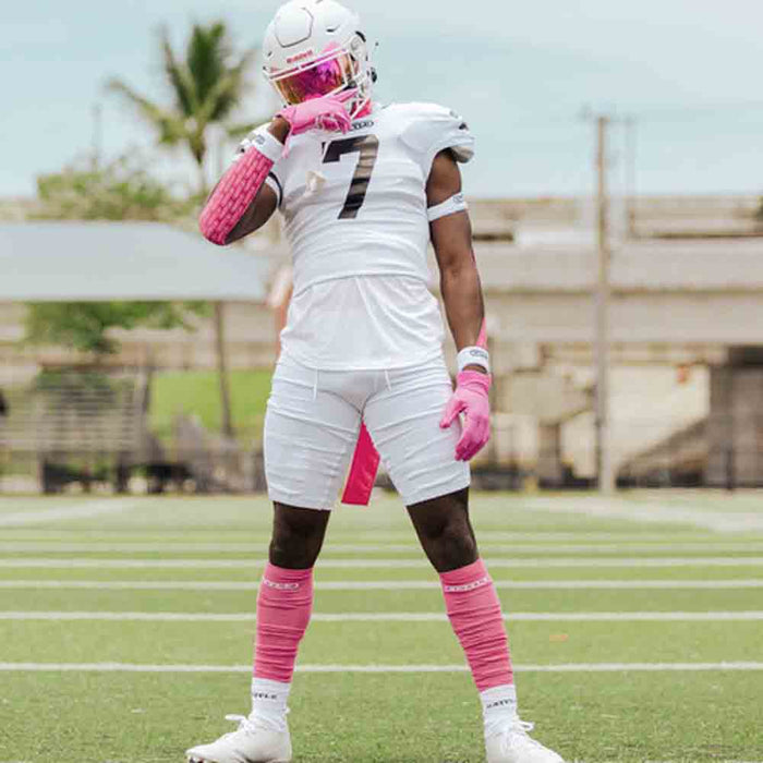 Football player wearing the Battle Adult White Long Sock Sleeves.