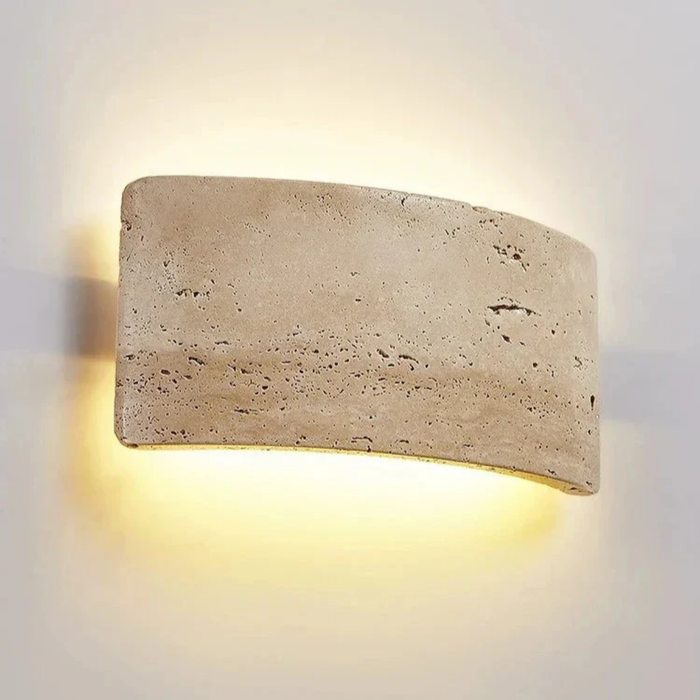 Arclume Yellow Travertine Wall Light mounted on a wall with warm up and down LED glow
