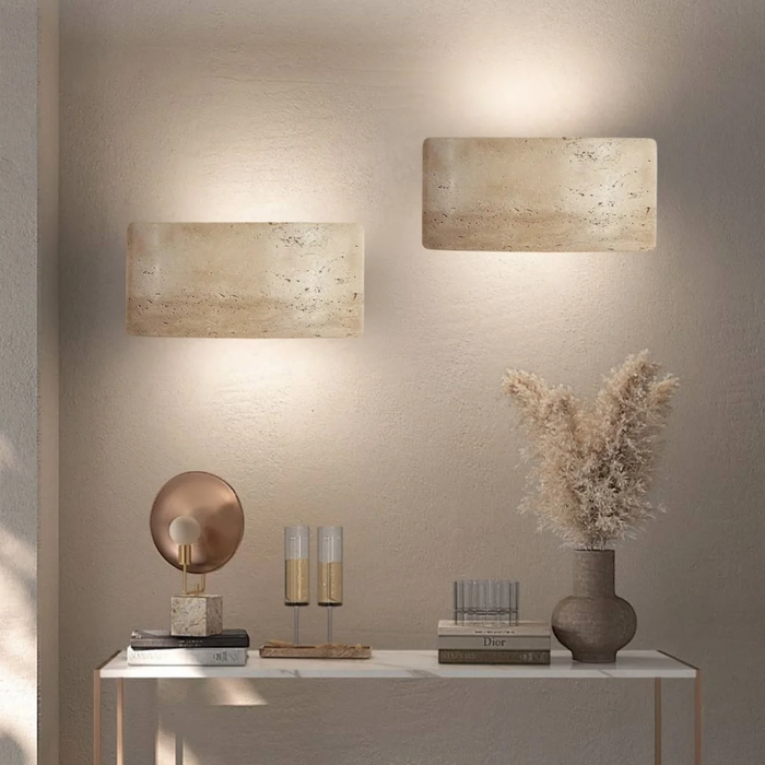 Pair of Arclume Yellow Travertine Wall Lights installed above a console table with vases and candles