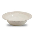A white ceramic bowl with a lacy rim design