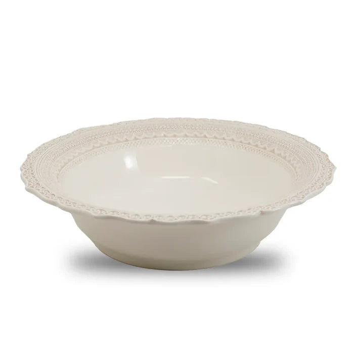 A white ceramic bowl with a lacy rim design