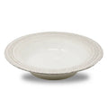 White ceramic bowl with decorative lace styled rim on a white background