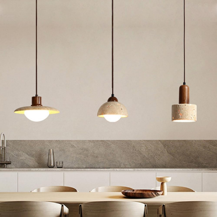 Three Aurelia Travertine Pendant Light designs, saucer, dome, and cylinder, hanging together in a kitchen