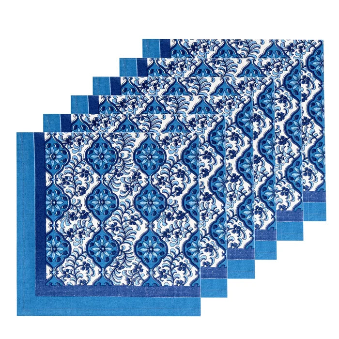 Five matching napkins with a blue and white damask floral pattern, arranged in a staggered stack