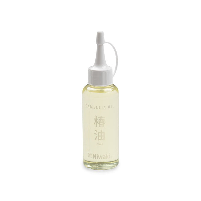Bottle of camellia oil with white cap and Niwaki branding on white background
