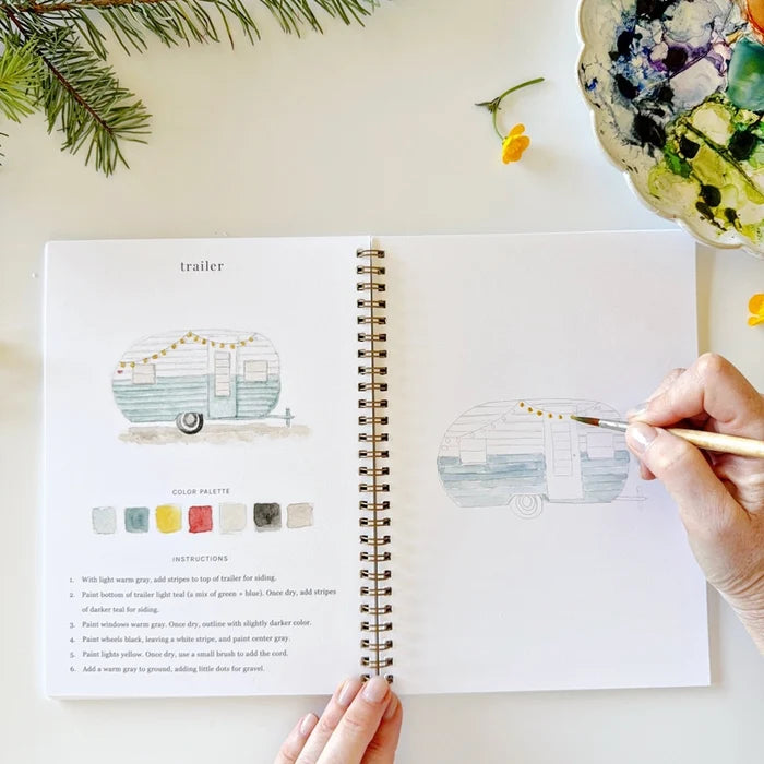 Person painting a camper illustration in a coloring book