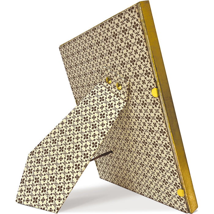 A square decorative picture frame with a gold-toned metal border and a beige backing board covered in a repeating black floral pattern, shown standing at an angle on a white background.