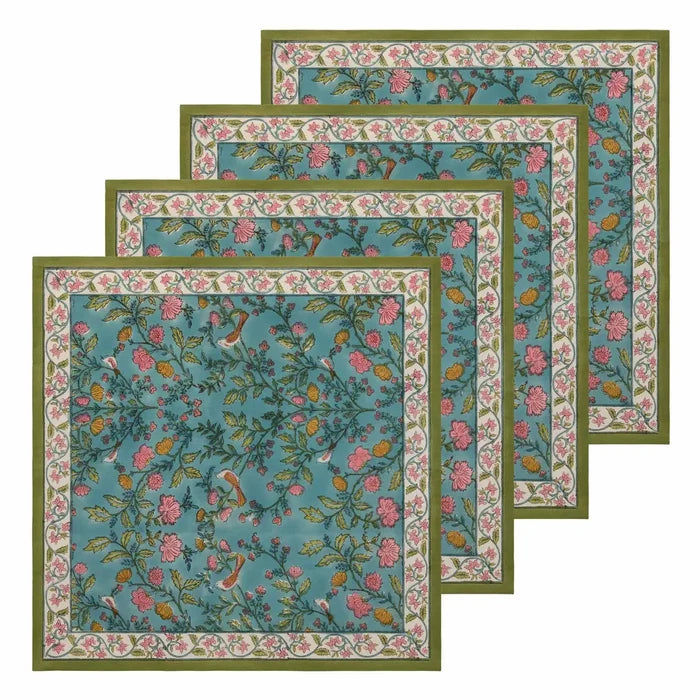 Set of four floral blue printed floral napkins with a green border