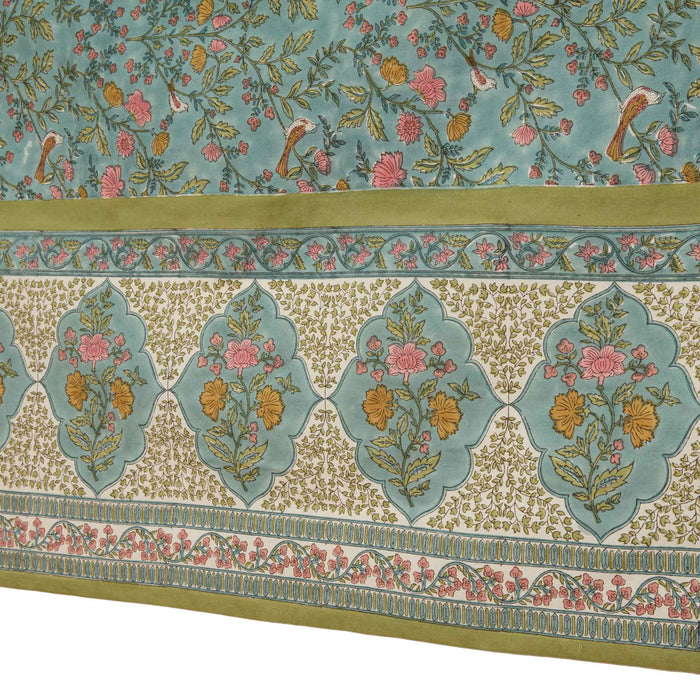 Decorative green and blue tablecloth with intricate patterns