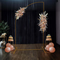 Elegant floral backdrop with balloons and dessert tables for events.