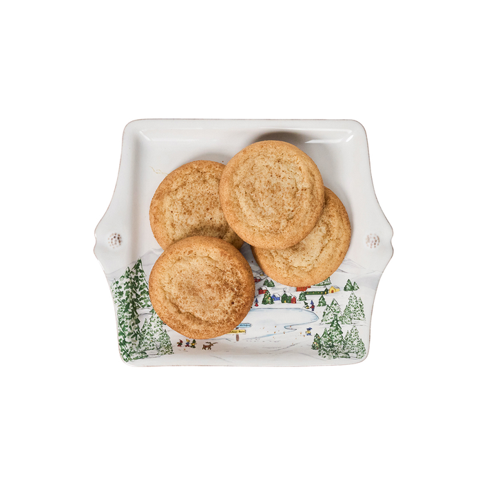 Three cookies on a white square tray   painted with a winter scene