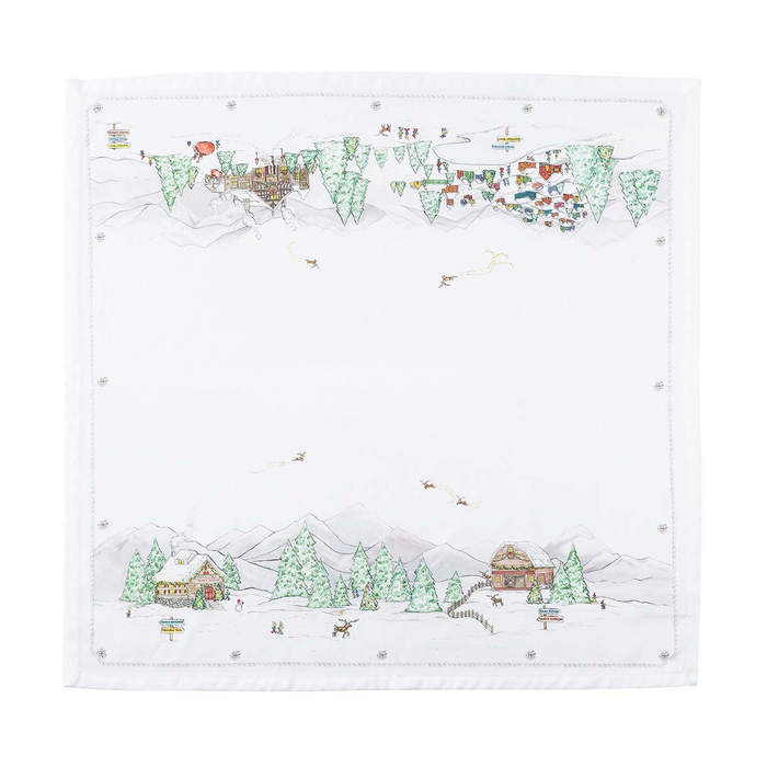 A square white fabric napkin  featuring a winter mountain village scene with trees, cabins, sleighs, and small snowflakes and hem stitching around the border