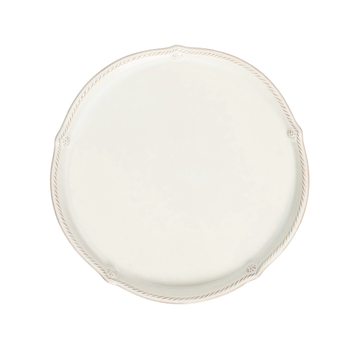 An off-white ceramic charger plate with a decorative rope border and small floral details at the corners, shown from a top-down view on a white background.