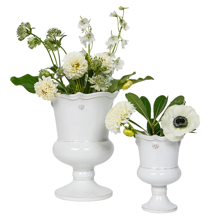 Two white decorative vases with floral arrangements on a white background