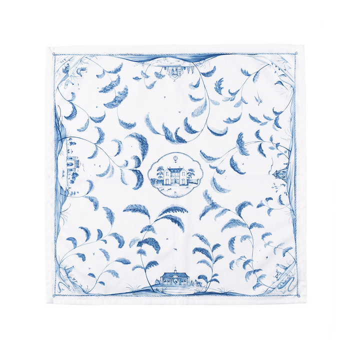 Blue and white patterned napkin with house illustration in the center