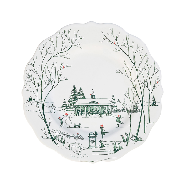 Decorative plate with a green painted winter scene design featuring trees, a pavilion, and people dancing in a snowy landscape.