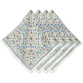 A stack of white napkins with an intricate botanical and floral pattern in shades of blue, green, and brown