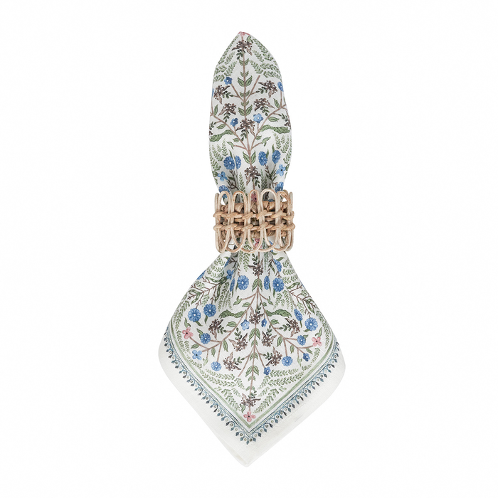 Decorative napkin with floral pattern held with a wicker napkin ring