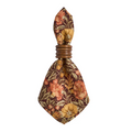 Willa amber floral patterned napkin in a Juliska Bilbao ring on a white background