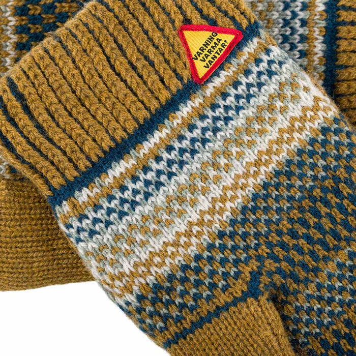 Close-up of a knitted garment with a pattern and a visible brand label.