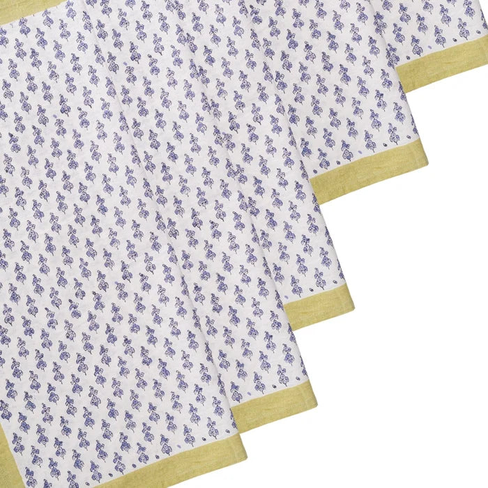 folded napkins with a blue floral pattern and yellow border