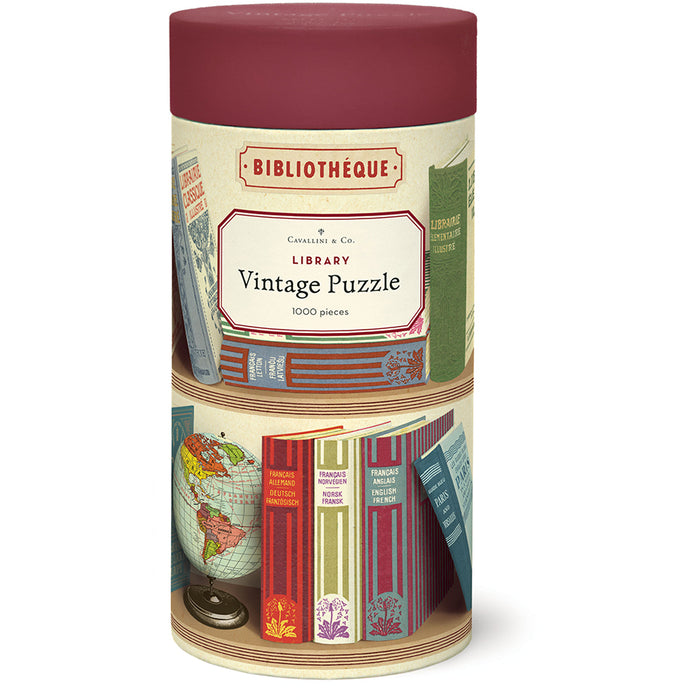 cylindrical packaging for a vintage puzzle with book and globe design