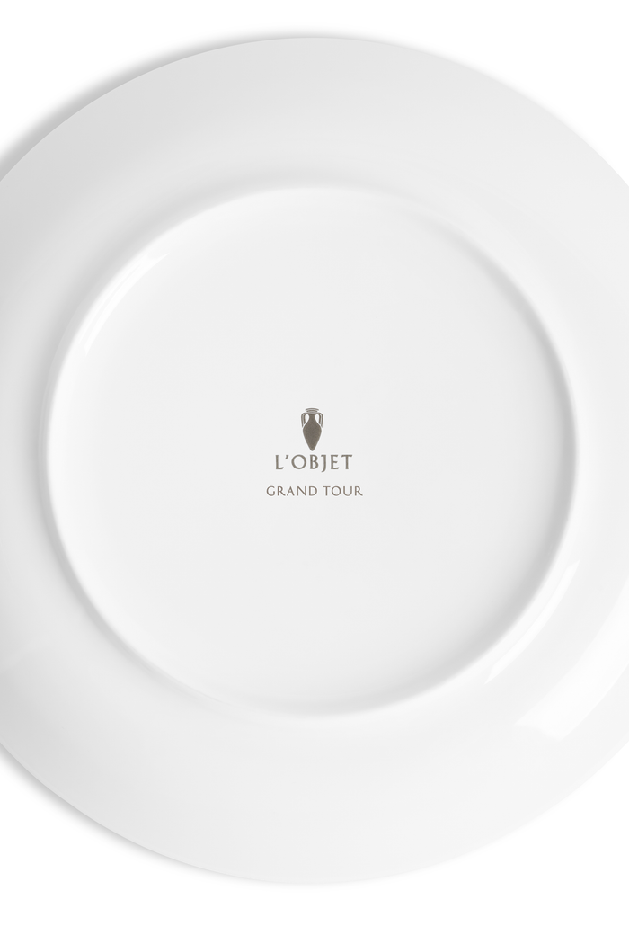 The white underside of a porcelain plate with the L'Objet logo and the words "grand Tour" inscribed