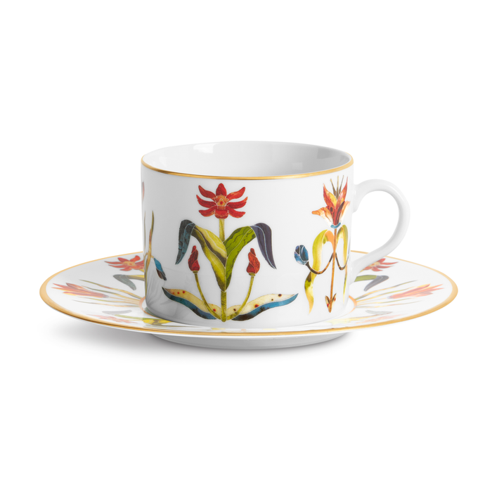 White teacup and saucer with colorful floral design