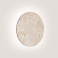 Lunaro Travertine Round Wall Sconce - front view lit with soft halo glow