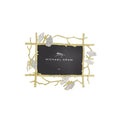 A gold-colored metal picture frame with a butterfly motif and white enamel accents, branded by Michael Aram.