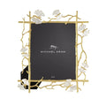 A gold-colored metal picture frame with a butterfly and ginkgo leaf design, featuring white enamel accents, from the Michael Aram brand.