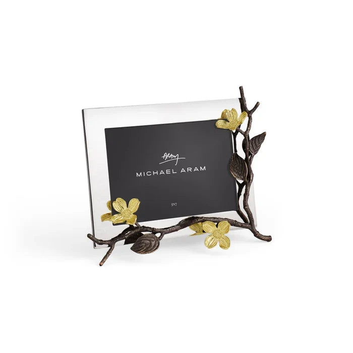 Silver photo frame with dogwood floral design on a white background in a 7 by  5 inch orientation