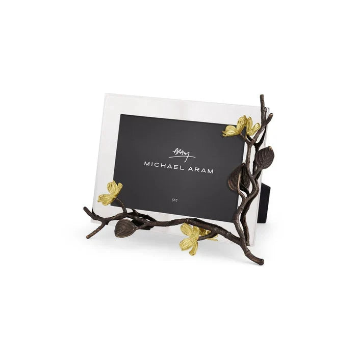 Silver photo frame with dogwood flowers branch and leaf design on a white background