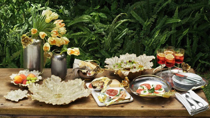 michael aram tulip items spread on table with charcuterie and bouquets