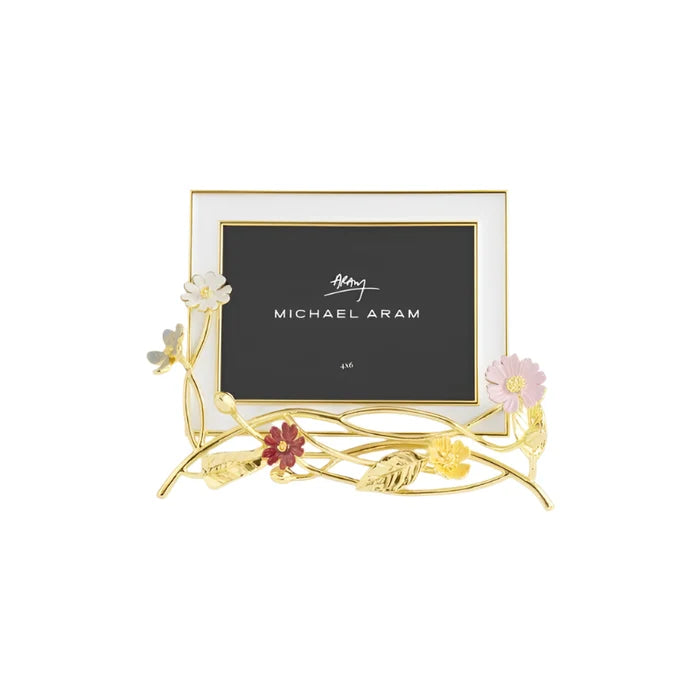 A gold-colored metal photo frame with a floral design, featuring pink and white flowers on the sides, holding a black background with the text 'Michael Aram' and '4x6'.