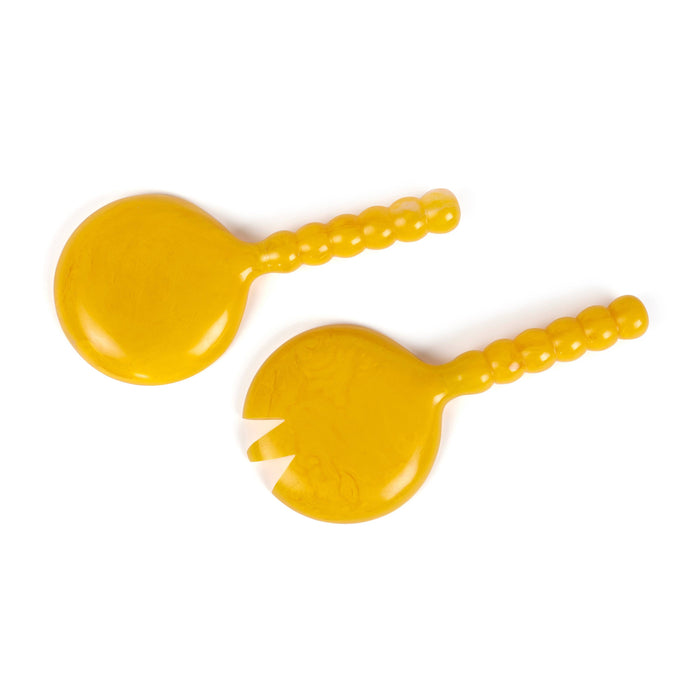 Two yellow silicone baby teething toys with textured, beaded handles and one smooth circular disc, shown on a plain white background.