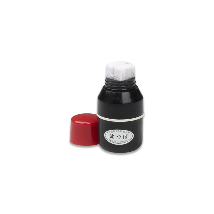 Black Niwaki oil dipsenser bottle with wadding and red cap on white background