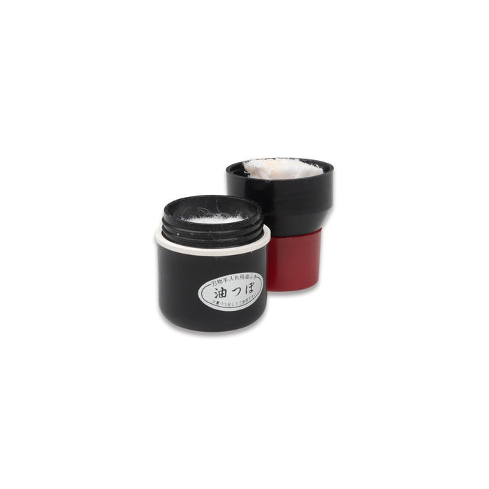 Black Niwaki oil dipsenser bottle with wadding and red cap on white background