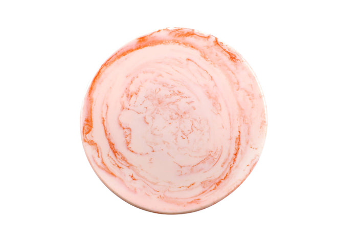 Round pink bath bomb on a white background