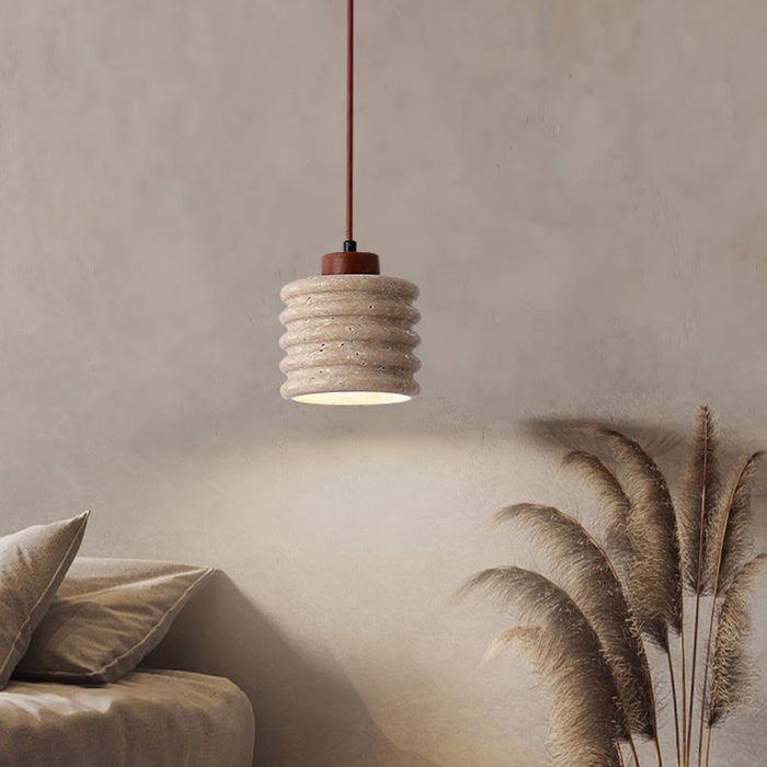 Ribelle Travertine Pendant Light - lifestyle above a sofa with pampas grass decor