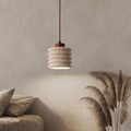Ribelle Travertine Pendant Light - lifestyle above a sofa with pampas grass decor