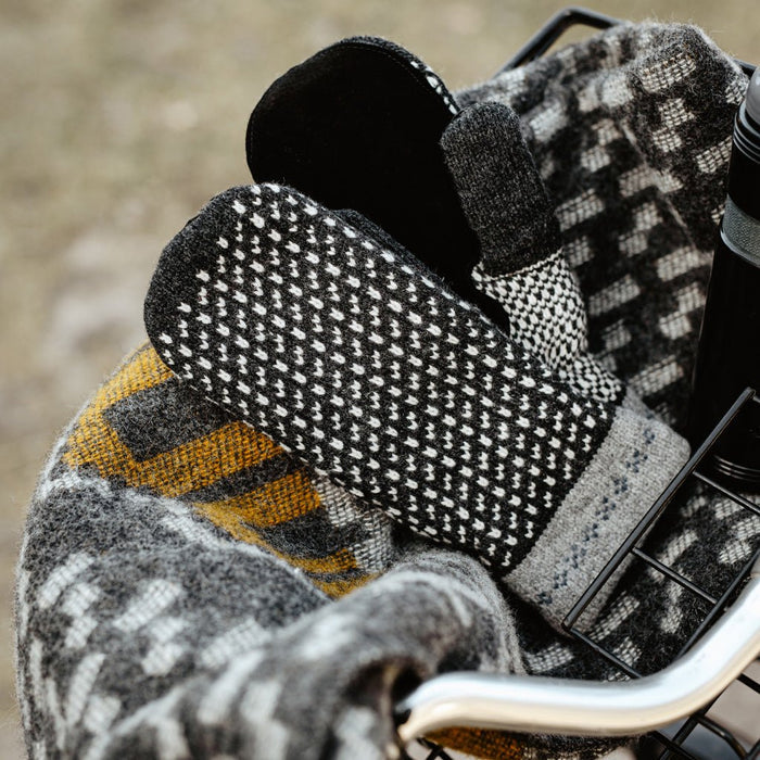 Wool mittens with pattern in bike basket.
