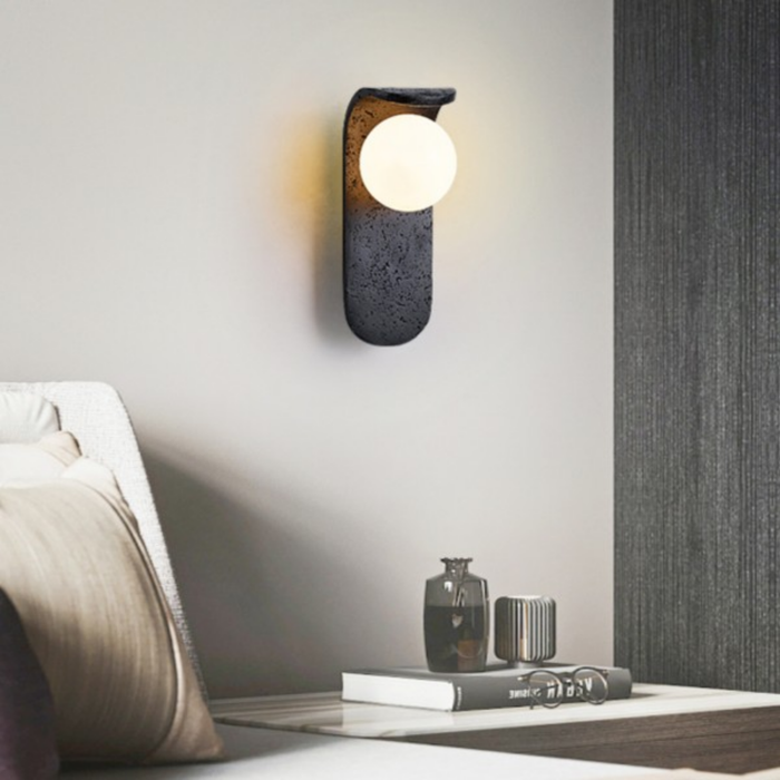Skatera Travertine Wall Lamp installed above a bedside table in a modern bedroom